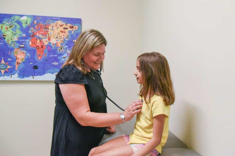 Smiling pediatrician and patient our difference at commonwealth pediatrics