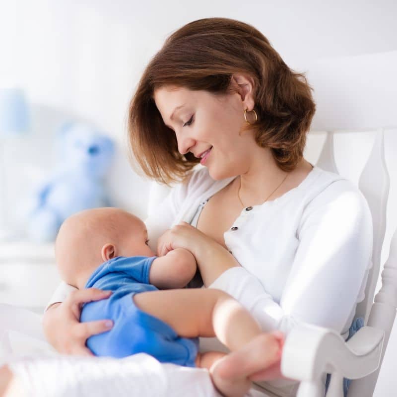 Mom breastfeeds new born healthy baby