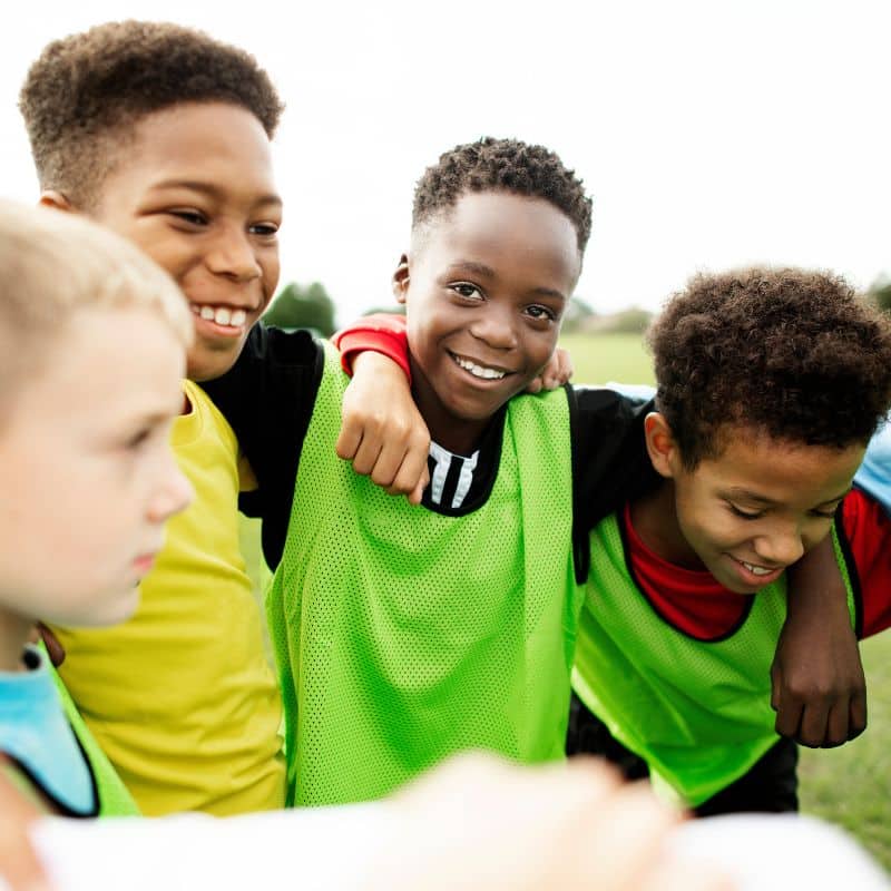 team huddle kids soccer boys smiling active healthy